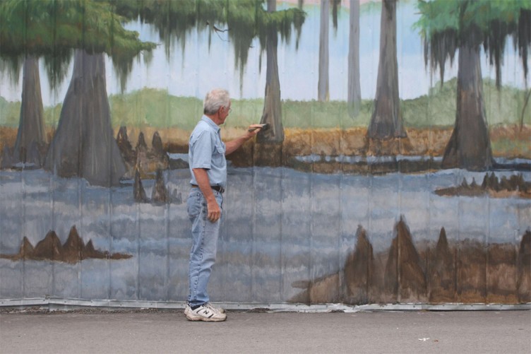 Terry Smith at work on the newest mural in Manning